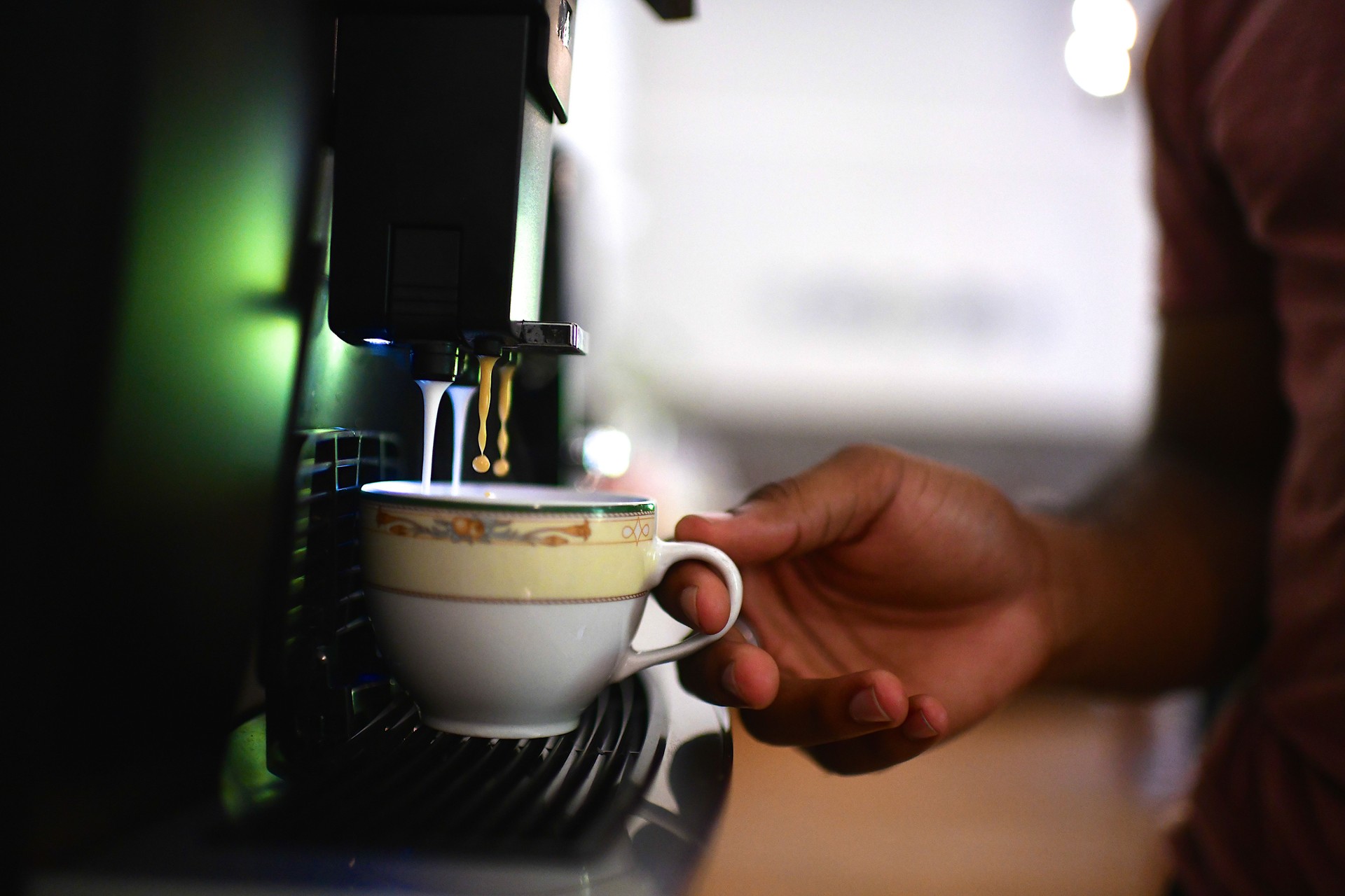 Gen Z male office worker getting freshly brewed coffee from the office coffee machine by eSafe Vending.